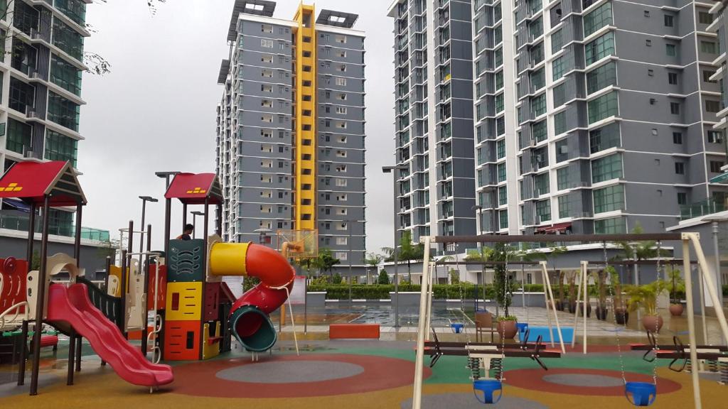 a playground in a city with tall buildings at Vista Alam Studio in Shah Alam