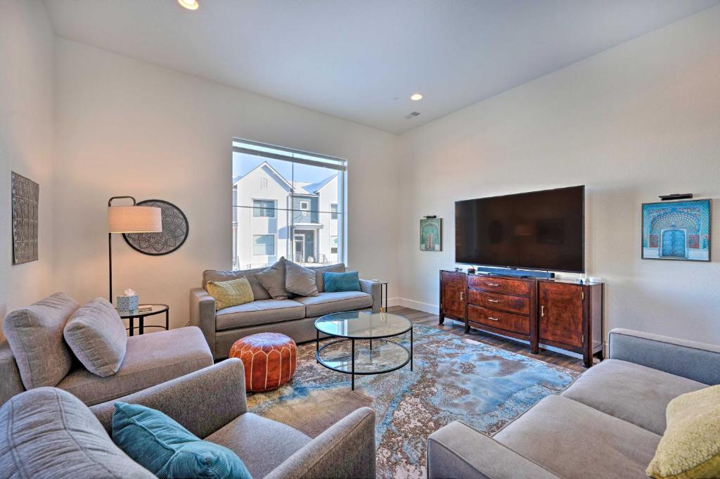 a living room with couches and a flat screen tv at Modern Townhome, Day Trip to Colorado Ski Resorts! in Louisville