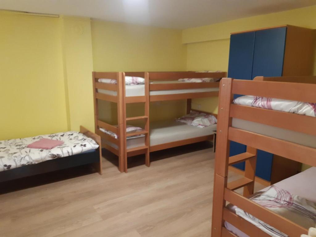 a room with three bunk beds and a couple of bunkers at Apartman Novi Sad - Apartment Novi Sad in Sremska Kamenica
