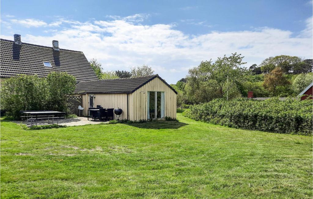 a small wooden shed in a yard with a grass field at Stunning Home In Anholt With 3 Bedrooms in Anholt