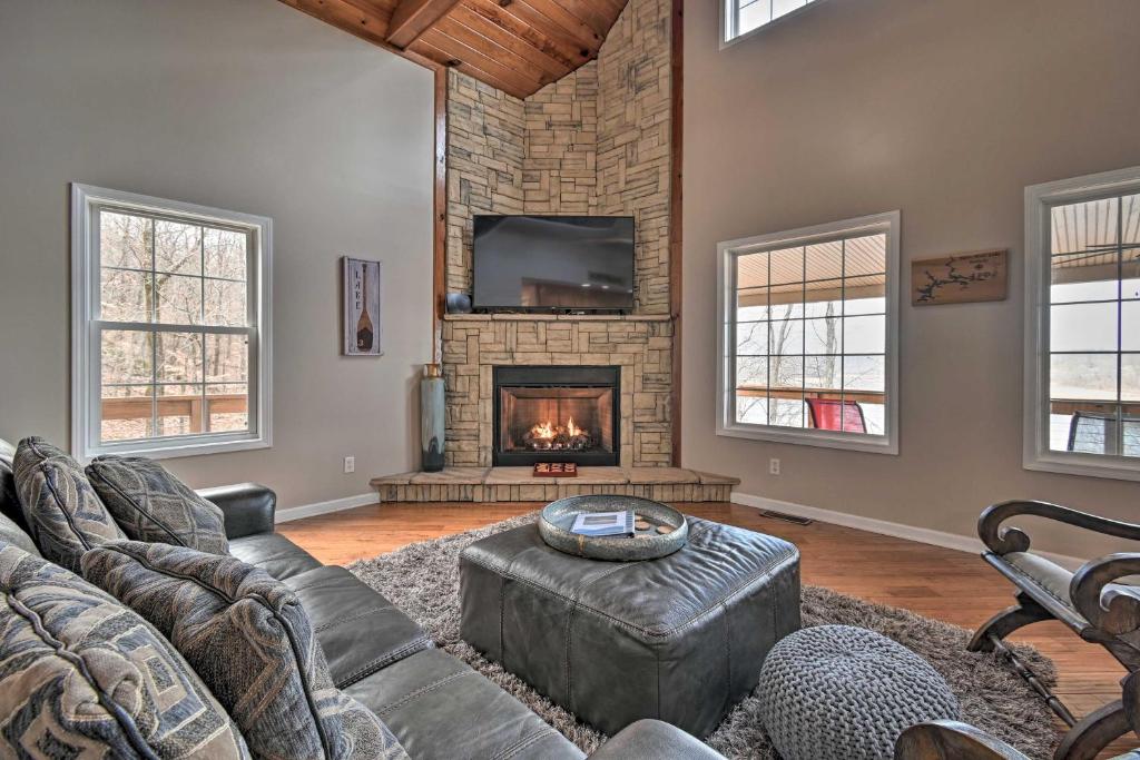 a living room with a couch and a fireplace at Lakefront Retreat with Views, Near Mammoth Cave! in Cub Run