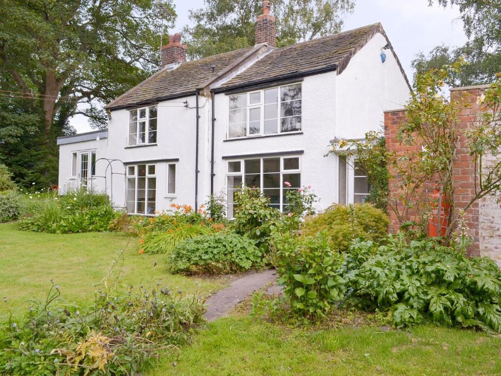 an old house with a garden in front of it at The Mill Cottage in Ault Hucknall