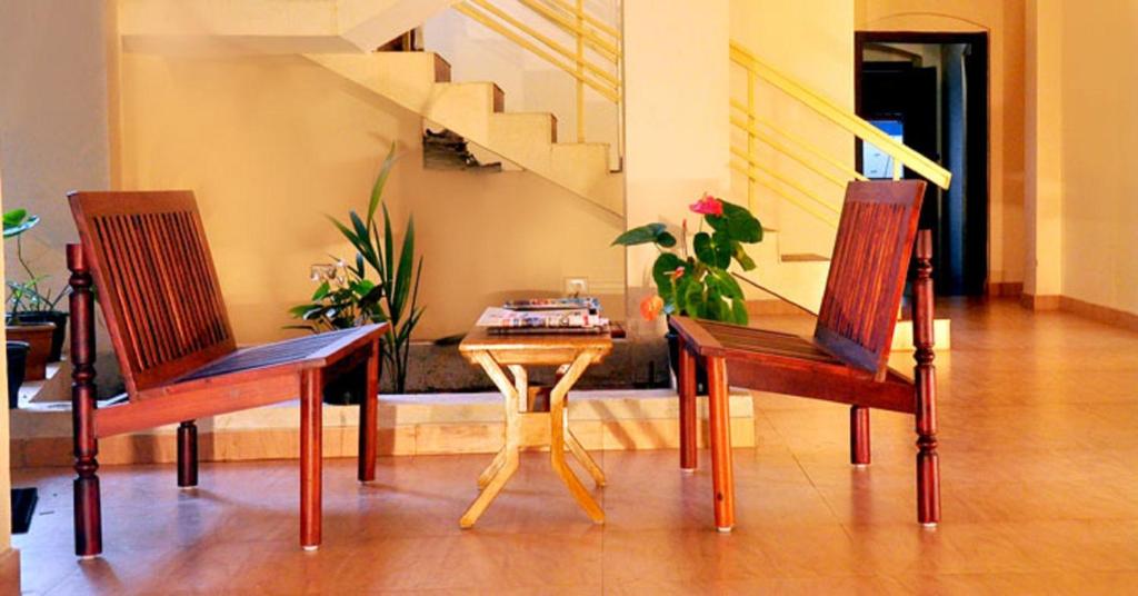 two chairs and a table in a living room at Wariyam Heritage in Trichūr