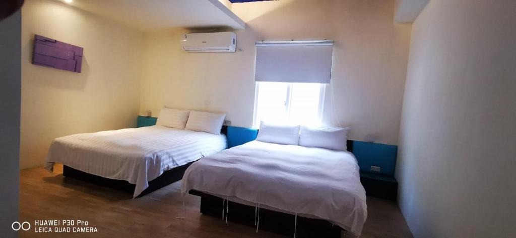 Postel nebo postele na pokoji v ubytování Nandu Inn
