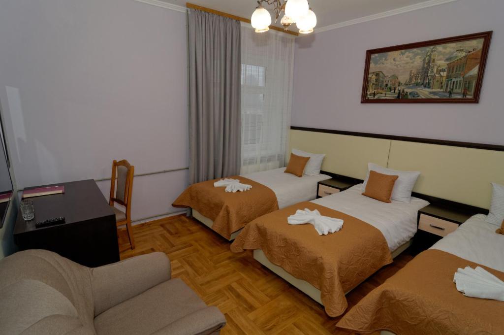 Postel nebo postele na pokoji v ubytování Pysanka Hotel