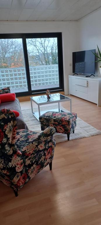 a living room with a couch and a coffee table at To feel good: Quiet apartment, between Köln and Düsseldorf in a 3-family house in Leverkusen