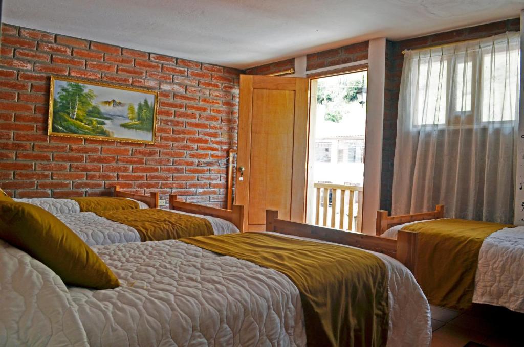 Postel nebo postele na pokoji v ubytování Lagoon Hotel Chugchilan