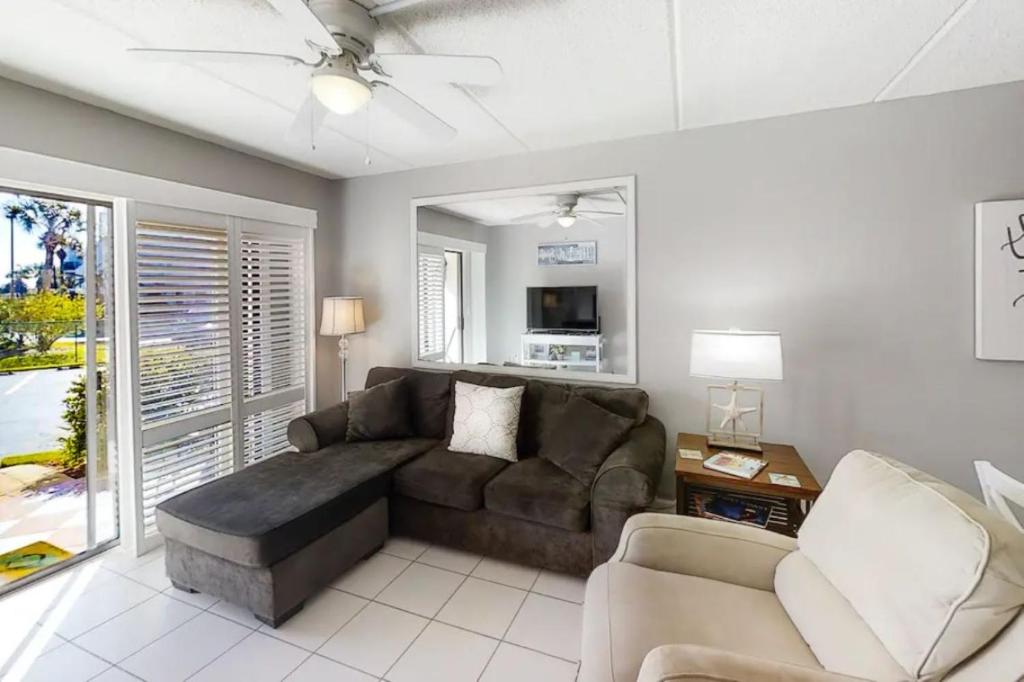 a living room with a couch and a tv at 3118 Near Ocean 1st Floor SE in Saint Augustine Beach
