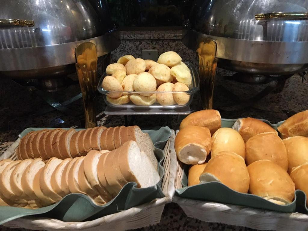 a bunch of bread and rolls on a table at Pousada dos Girassóis in Palmas