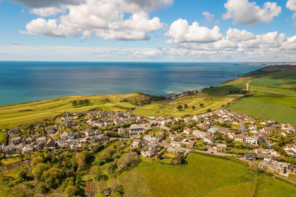 an aerial view of a small town next to the ocean at Finnygook Inn in Crafthole