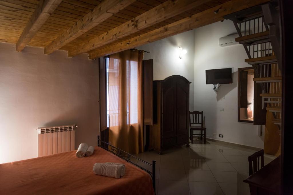 a bedroom with a bed with two towels on it at Alla Loggia Del Gattopardo in Palermo