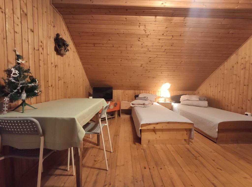 a attic room with two beds and a christmas tree at Western Tatras Slovakia in Oravský Biely Potok