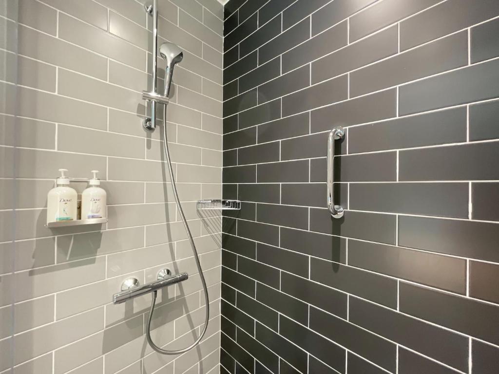 a bathroom with a shower with gray tiles at Holiday Inn Express - Ankara - Airport by IHG in Ankara