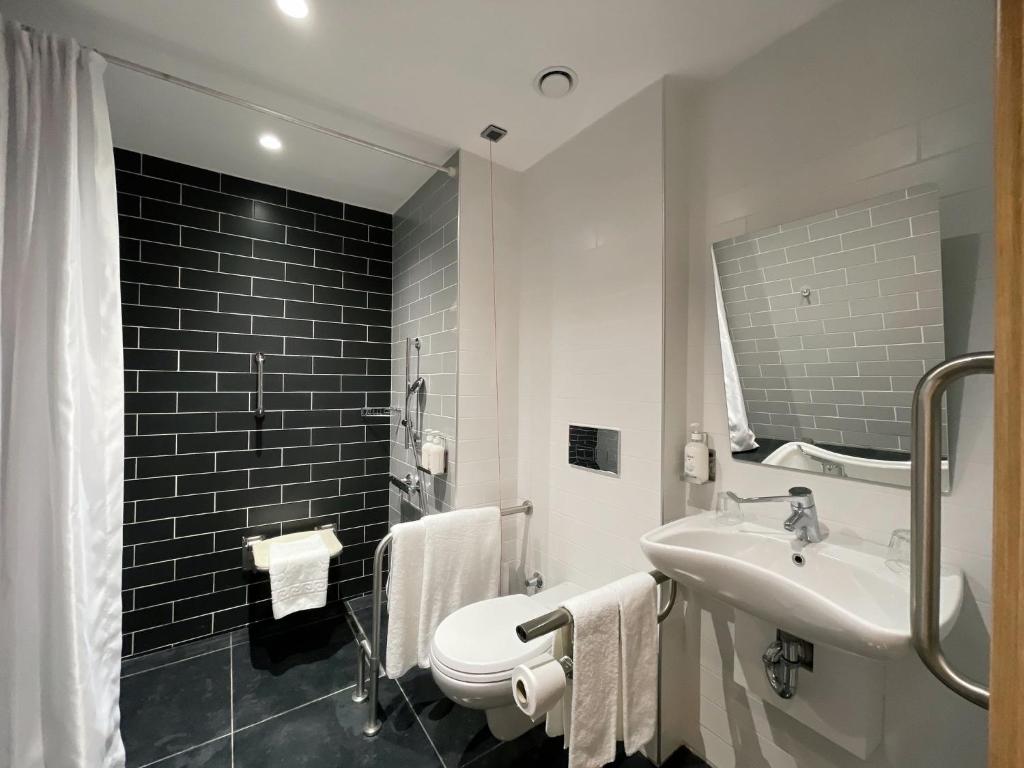 a bathroom with a sink and a toilet and a mirror at Holiday Inn Express - Ankara - Airport by IHG in Ankara