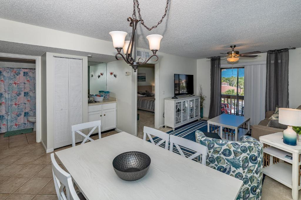 a dining room and living room with a table and chairs at Unit 4307 - Ocean Racquet Club in Saint Augustine Beach