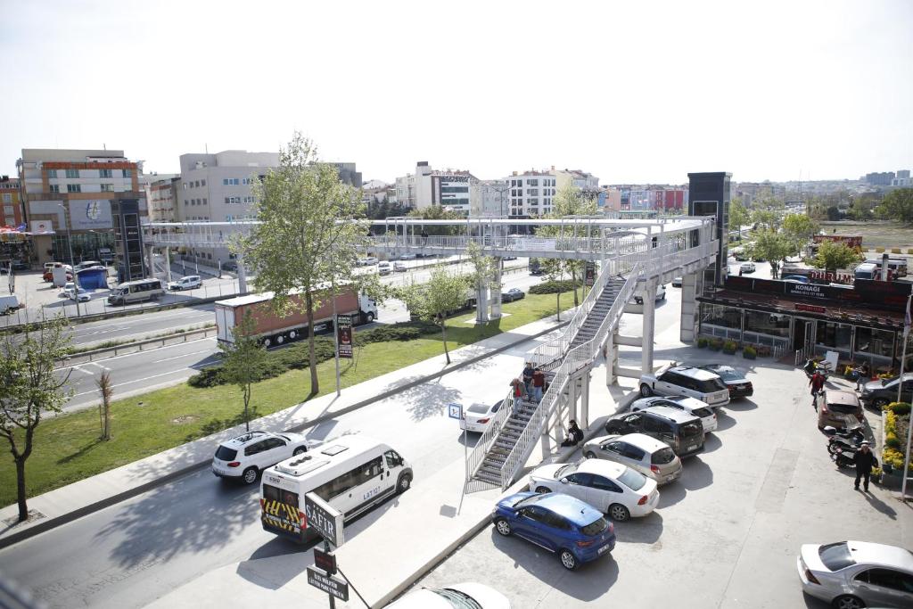 a parking lot with cars and a bus at Safir Hotels Silivri in Silivri