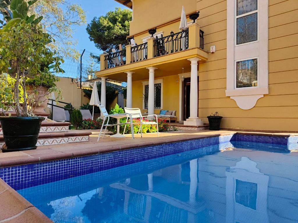 a house with a swimming pool in front of a house at Hotel Boutique Villa Lorena by Charming Stay Adults Recommended in Málaga