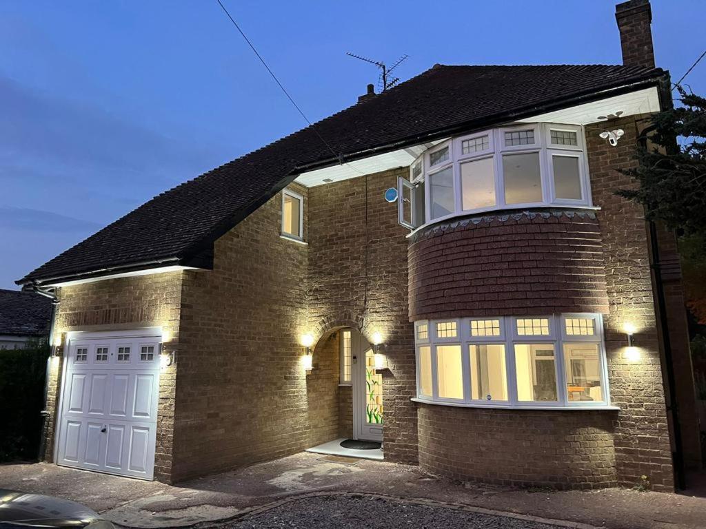 a brick house with a white door and a window at The Elegance in Chatteris