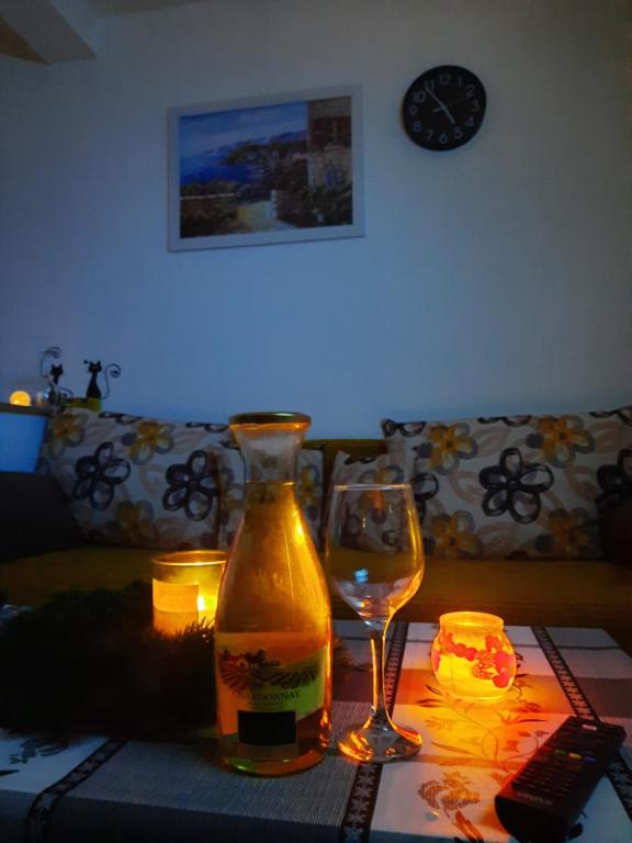 a table with a bottle and a wine glass on it at Mace MM :) in Šabac