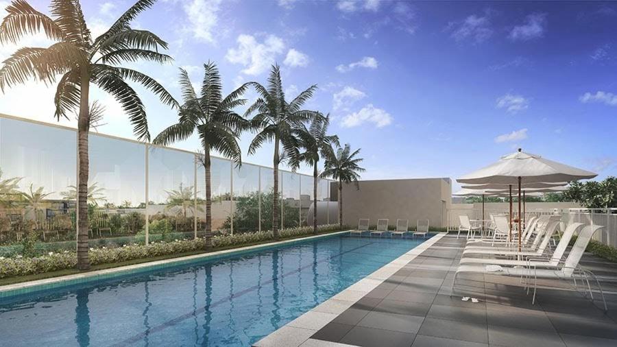 a swimming pool with palm trees and a building at Apartamento 1604 no Bosque com um quarto sala cozinha completa e uma vaga de garagem in Campinas