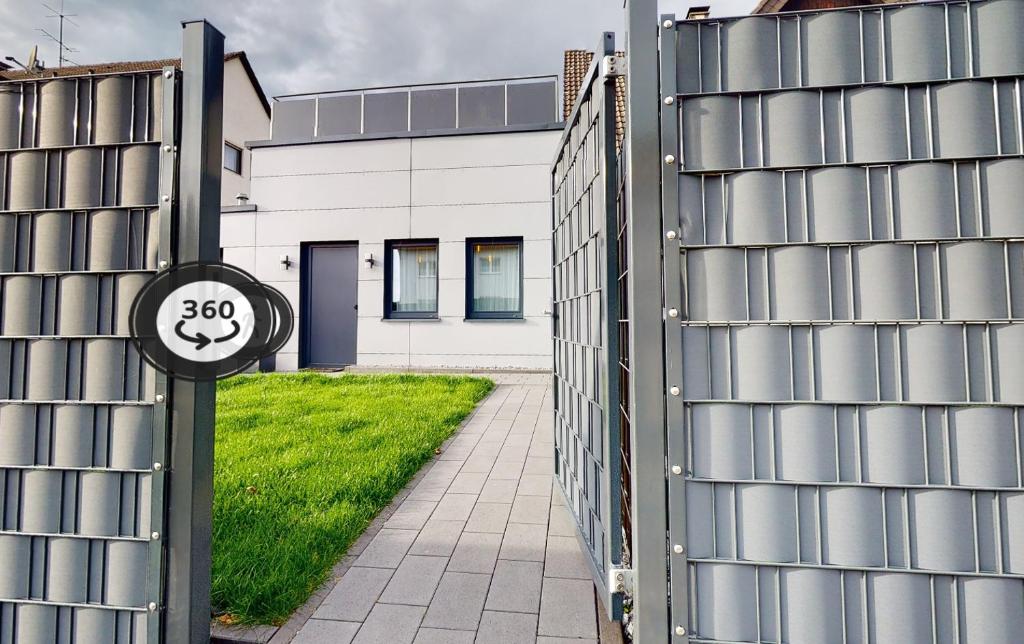 a gate to a house with a sign on it at Apartmenthaus Celik in Bielefeld