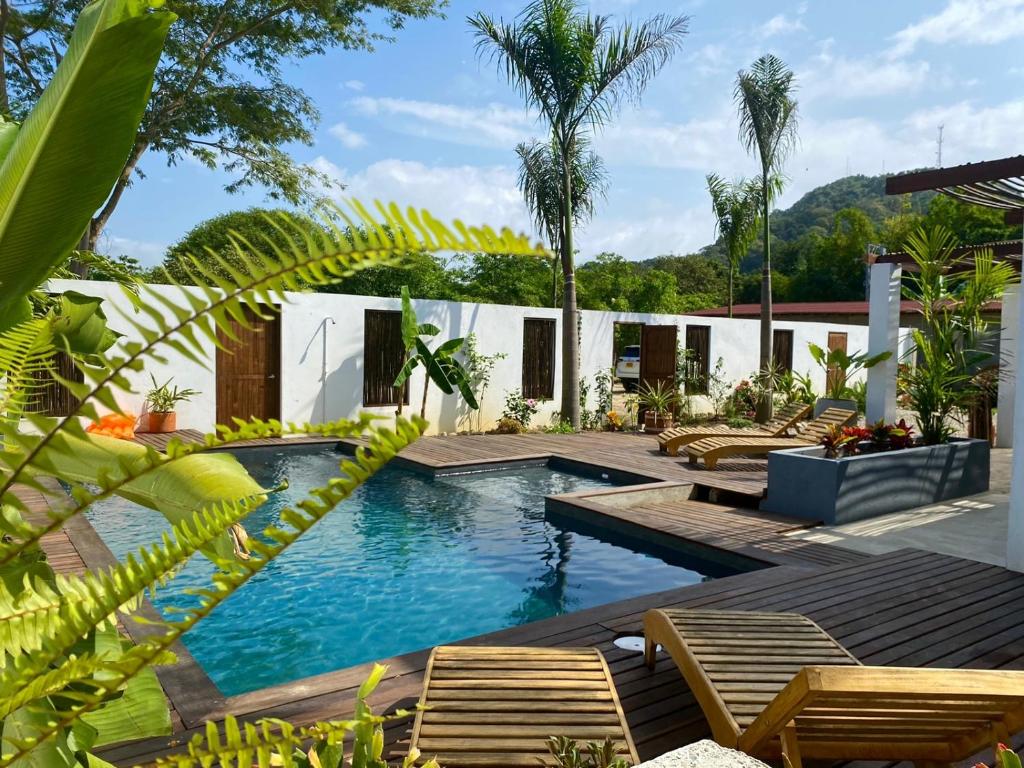 a swimming pool with chairs and a resort at Casa La Rayanna in Palomino