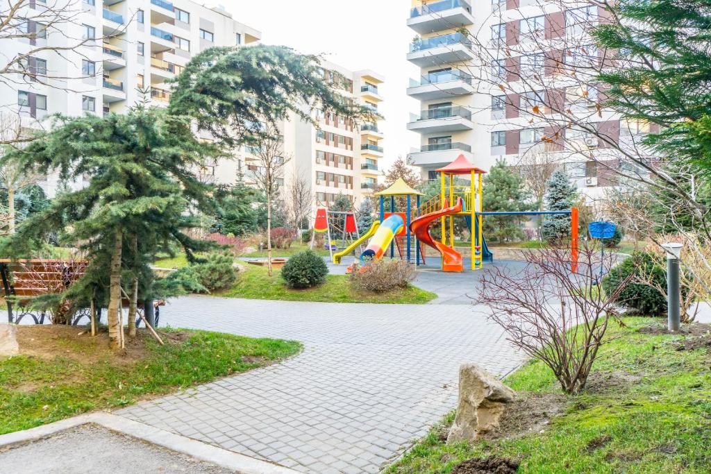 a playground with a slide in a park at Luxury Pipera in Voluntari
