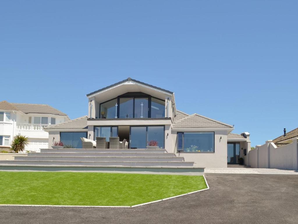 a rendering of a house with a green lawn at Deepwater Point Apartment in Torquay