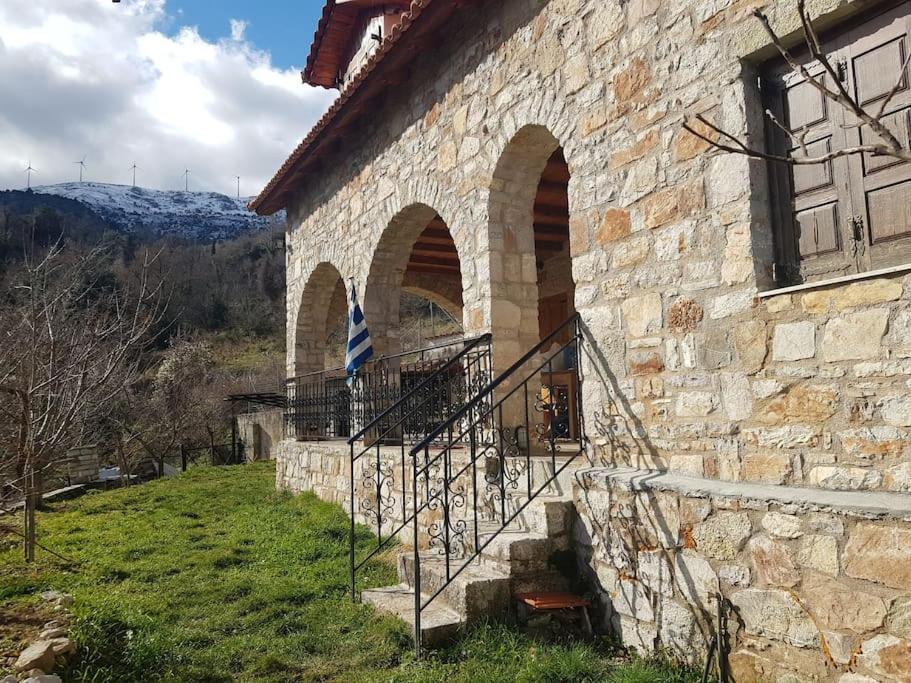 a stone building with a staircase next to a building at Stone Mountainhouse near Kalavryta, North Peloponnese, Greece 