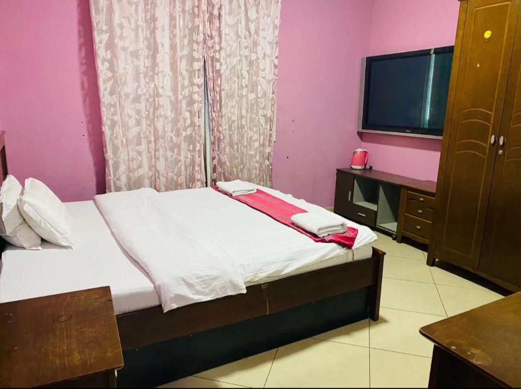 Postel nebo postele na pokoji v ubytování Jin Jie Residence