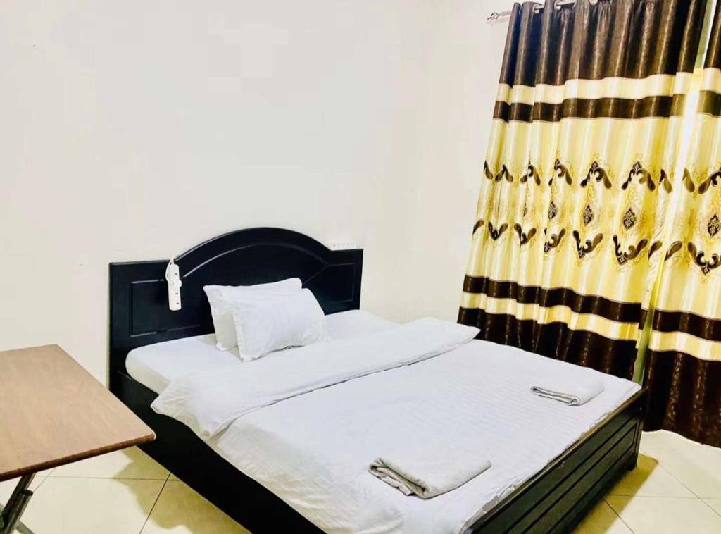 Postel nebo postele na pokoji v ubytování Jin Jie Residence