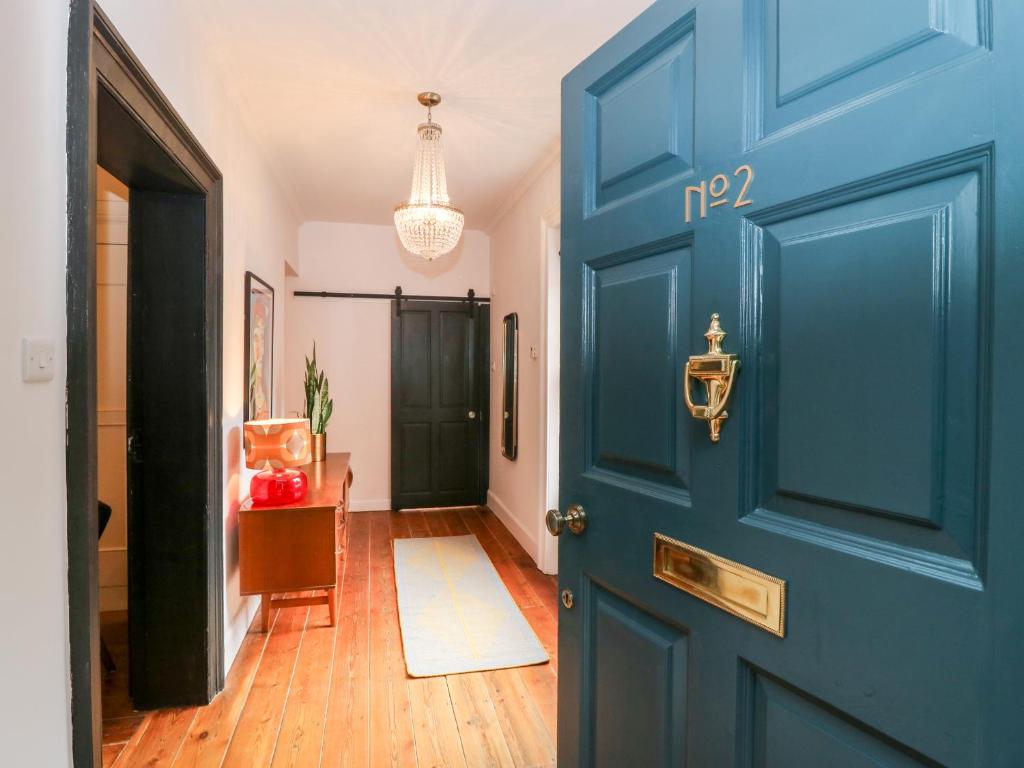 a blue door in a hallway with a table at No 2 Pepper Arden in Northallerton