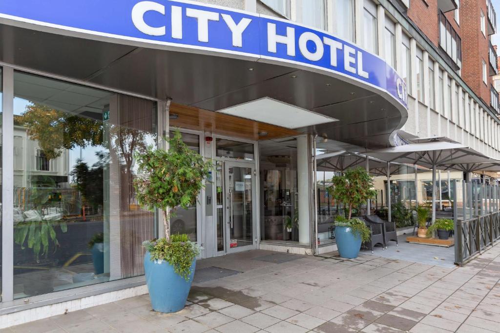 a city hotel with potted plants in front of it at Sure Hotel by Best Western City Jonkoping in Jönköping