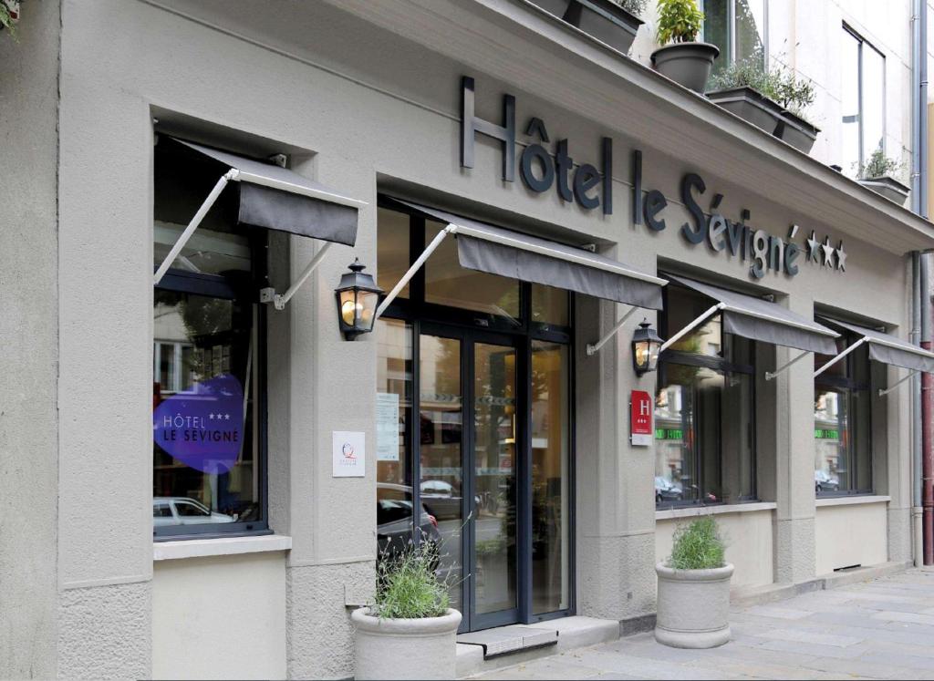 a store front of a store with a sign on it at Hotel Le Sevigne - Sure Hotel Collection by Best Western in Rennes
