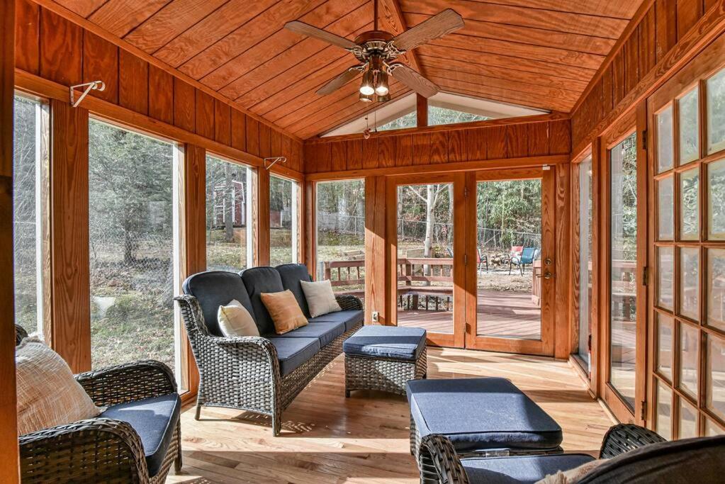 - une terrasse couverte avec un ventilateur de plafond et des chaises dans l'établissement Auburndale, à Asheville