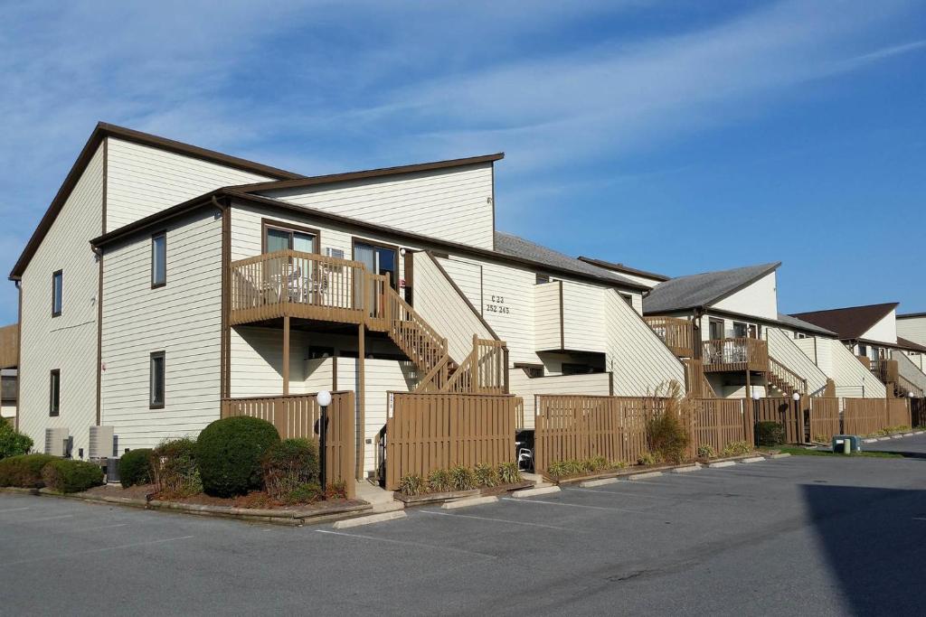 a large white house with a wooden fence at Club Ocean Villas II 19 condo in Ocean City