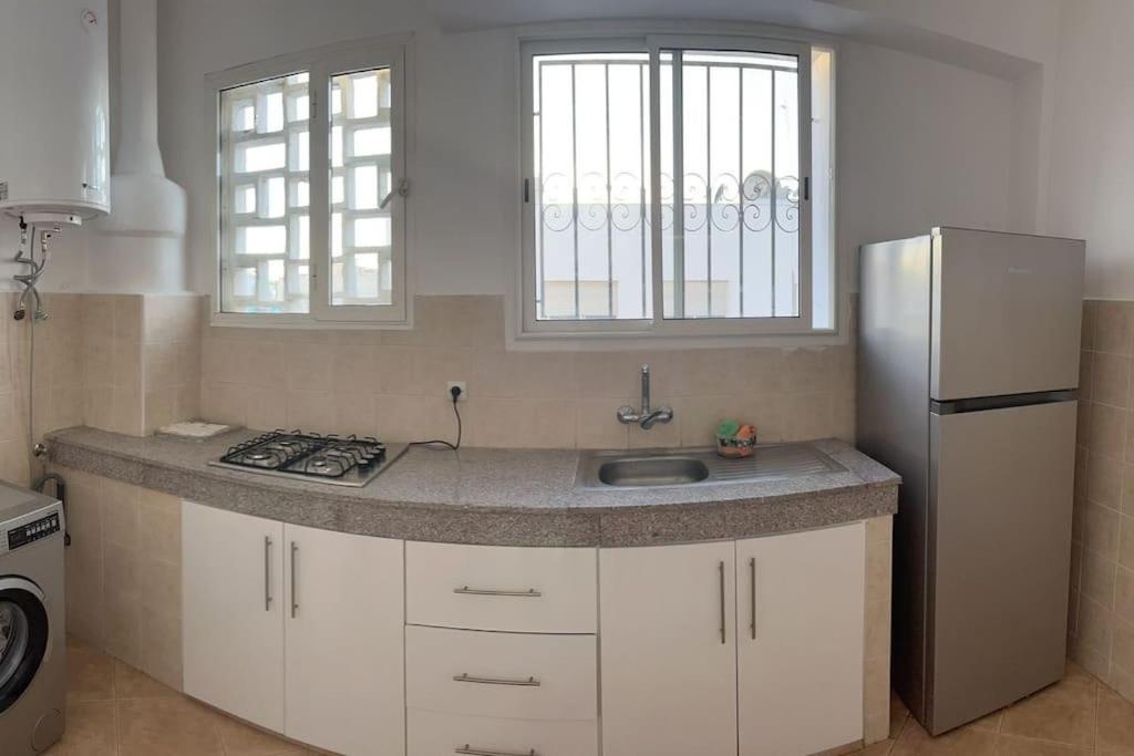 a kitchen with a sink and a refrigerator at Cozy place in the heart of rabat in Rabat