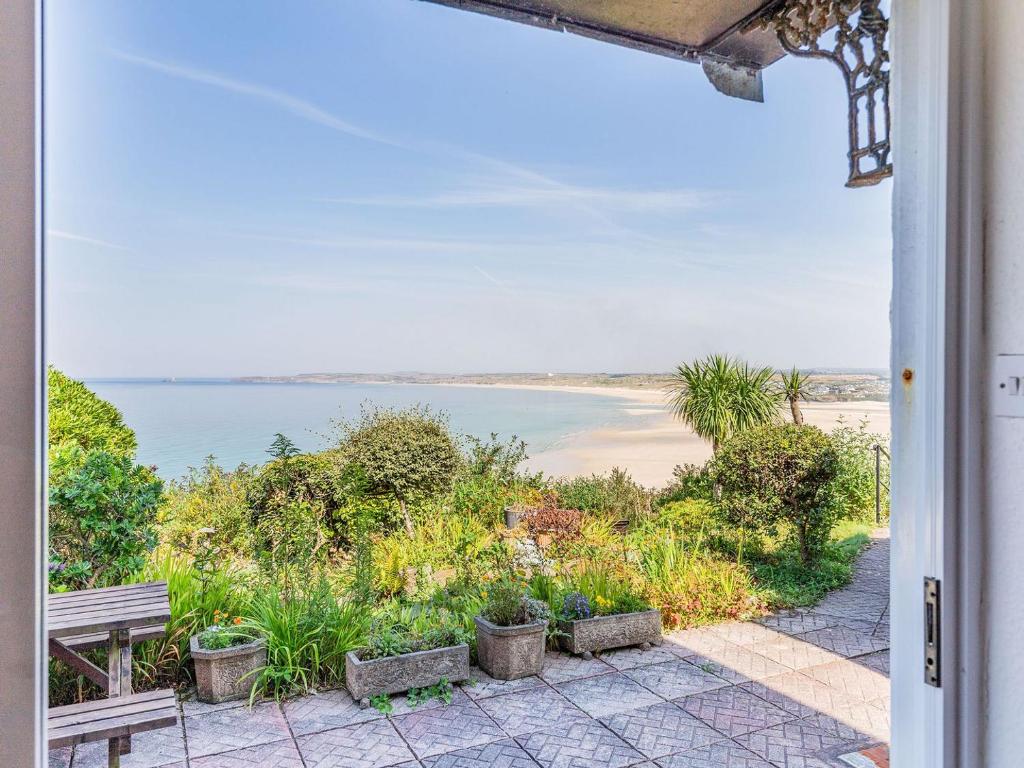 a view of the beach from the porch of a house at Studio Sea Urchin in Carbis Bay