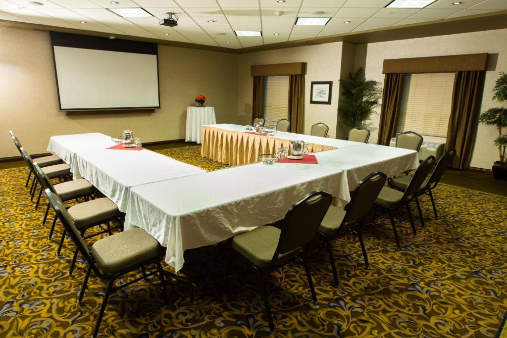 a conference room with a long table and chairs at The Kanata Fort Saskatchewan in Fort Saskatchewan