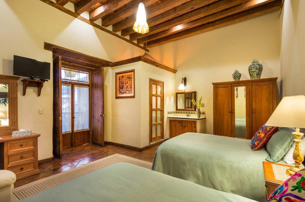Postel nebo postele na pokoji v ubytování Hotel Casa del Naranjo