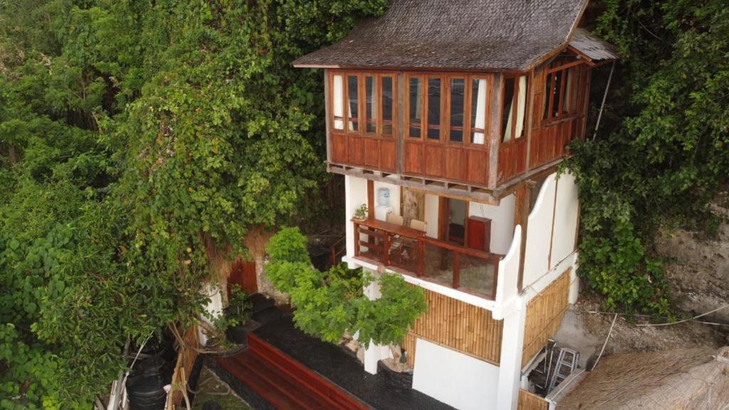 an overhead view of a house with a balcony at The Hidden Escapes- Unique Tiny Home on Bingin Beach with Breathtaking Ocean & Sunset Views in Uluwatu