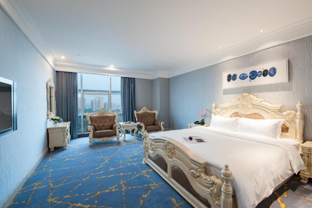 Postel nebo postele na pokoji v ubytování Nan Yang Royal Hotel