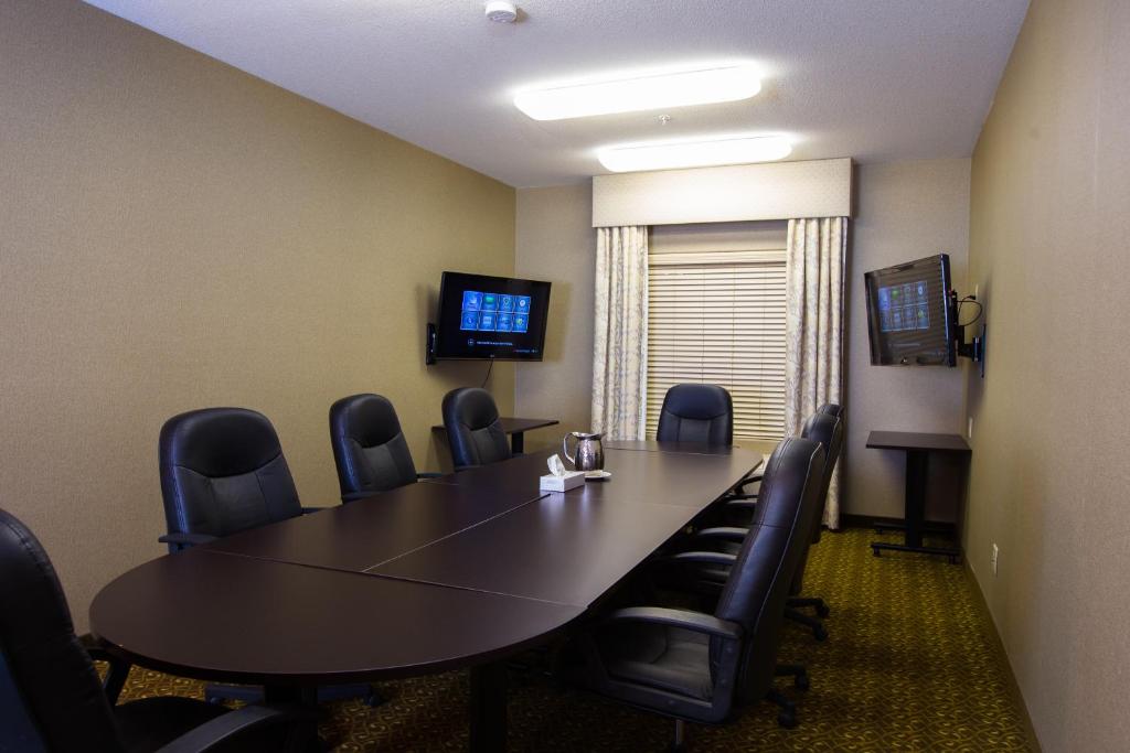 a conference room with a long table and chairs at The Kanata Fort Saskatchewan in Fort Saskatchewan