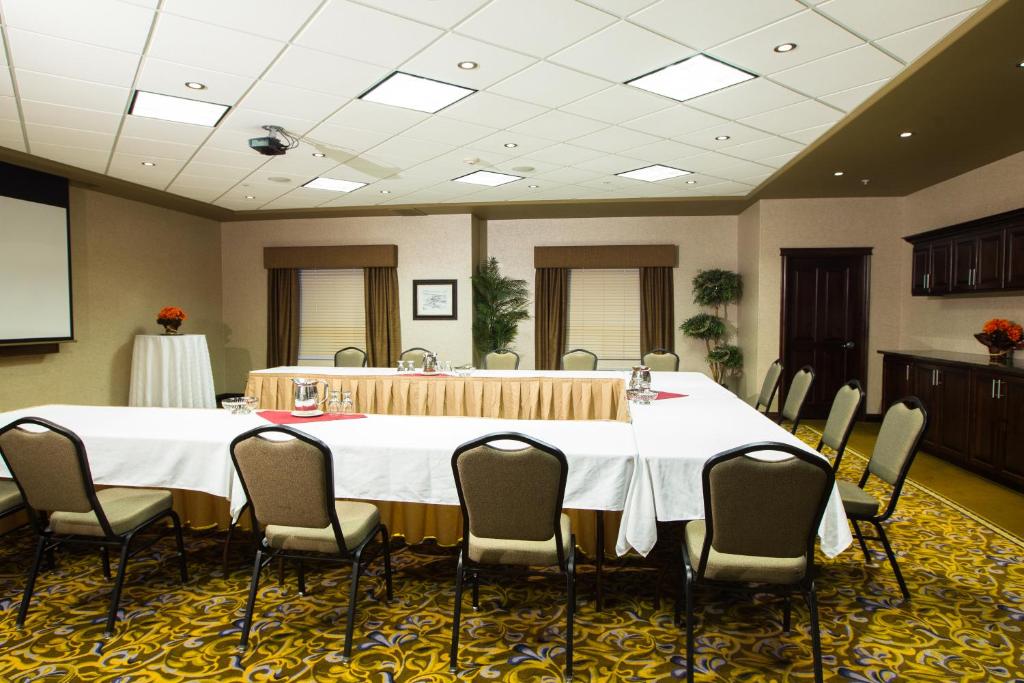 a conference room with a large table and chairs at The Kanata Fort Saskatchewan in Fort Saskatchewan