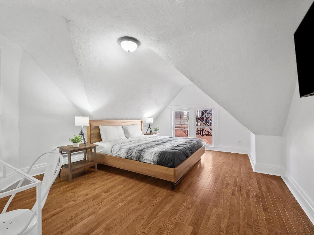 a white bedroom with a bed and a table at Bloomfield/Shadyside @K Spacious & Unique Private Bedroom with Shared Bathroom in Pittsburgh