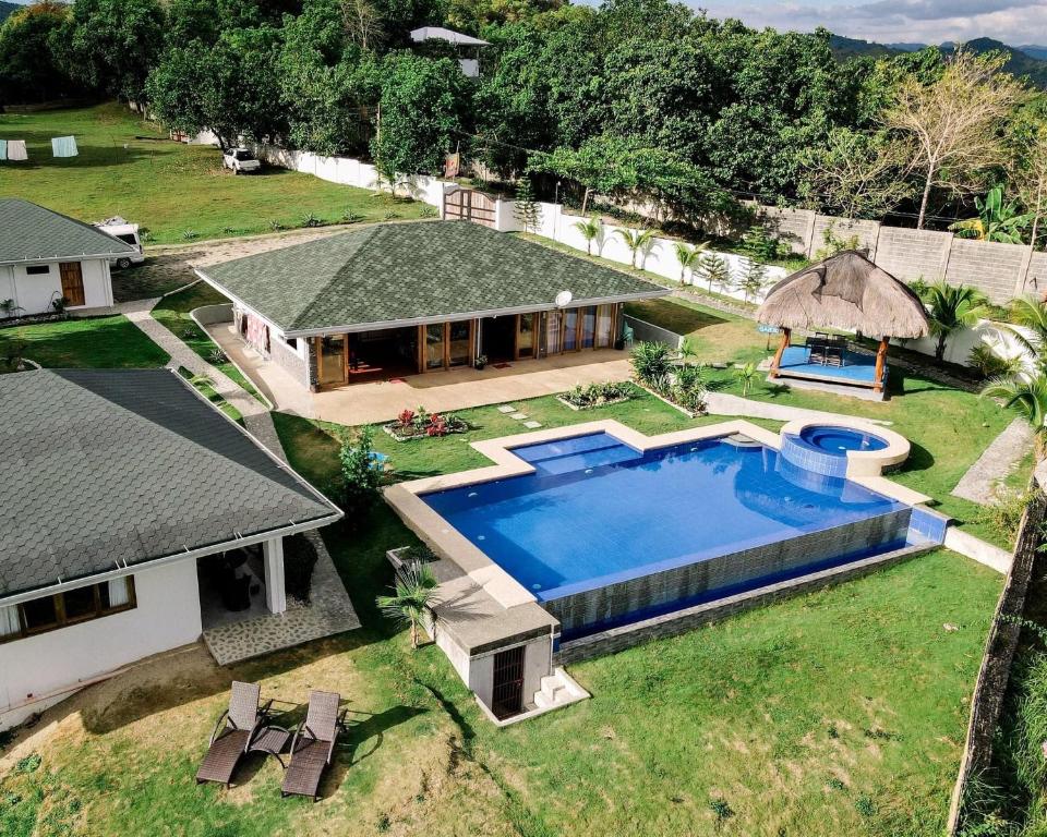 an aerial view of a house with a swimming pool at Villa MountainView Guesthouse in Dimiao