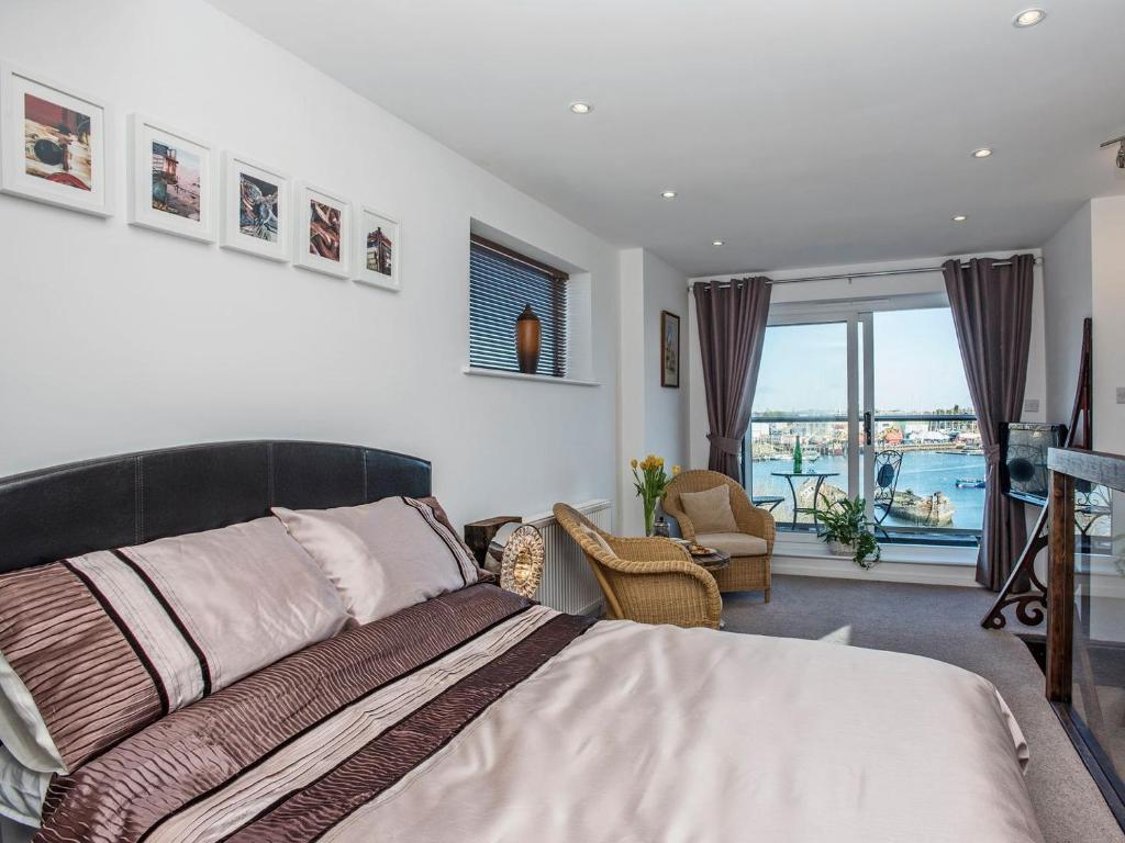 a bedroom with a bed and a view of the water at The Shipwreck in Oulton