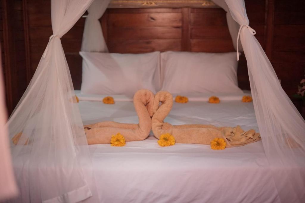 Letto o letti in una camera di Teba Junjungan Cottages