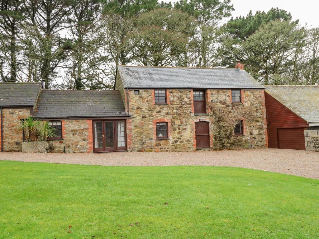 an old stone house with a large yard at Barn Cottage in Saint Erth