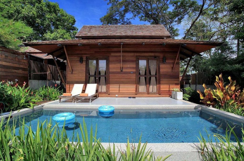 a small cabin with a pool in the backyard at Ananta Thai Pool Villas Resort Phuket in Rawai Beach